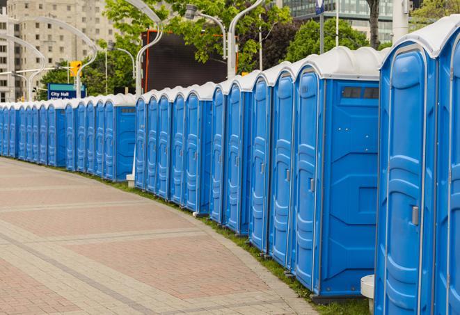 a line of portable restrooms at a sporting event, providing athletes and spectators with clean and accessible facilities in Bee Cave